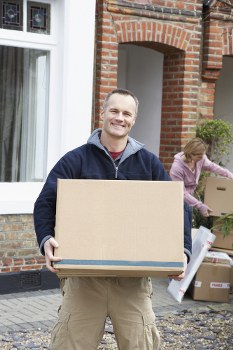 Furniture pick-up team handling bulky items in a Clapham residential street
